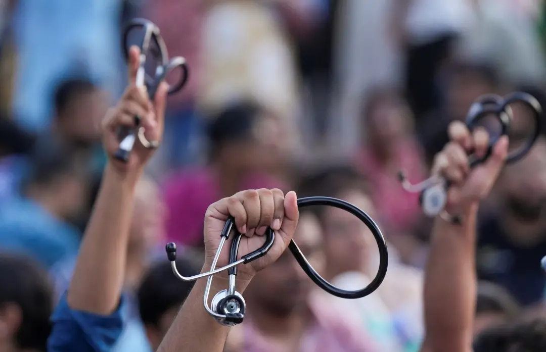 Junior doctors holding their stethoscope shout slogans as they sit on a dharna | File Photo:PTI