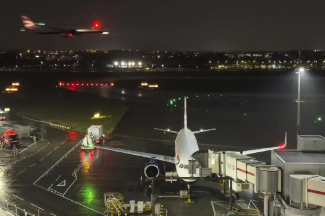 A plane is prepared whilst another airplane approaches landing at Heathrow Airport after a fire at an electrical substation shuttered Europe's busiest air travel hub in London. | Photo: AP