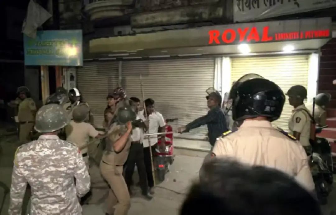 Police personnel use lathi charge after tensions broke out following a dispute between two groups, at Mahal in Nagpur. (ANI Photo)