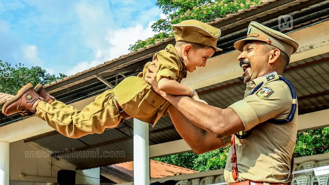 After the passing-out parade of sub-inspectors at the Thrissur Police Academy, A Kiran from Meppayur lifts his son Manav in joy | Photo: Maneesh Chemencheri/ Mathrubhumi