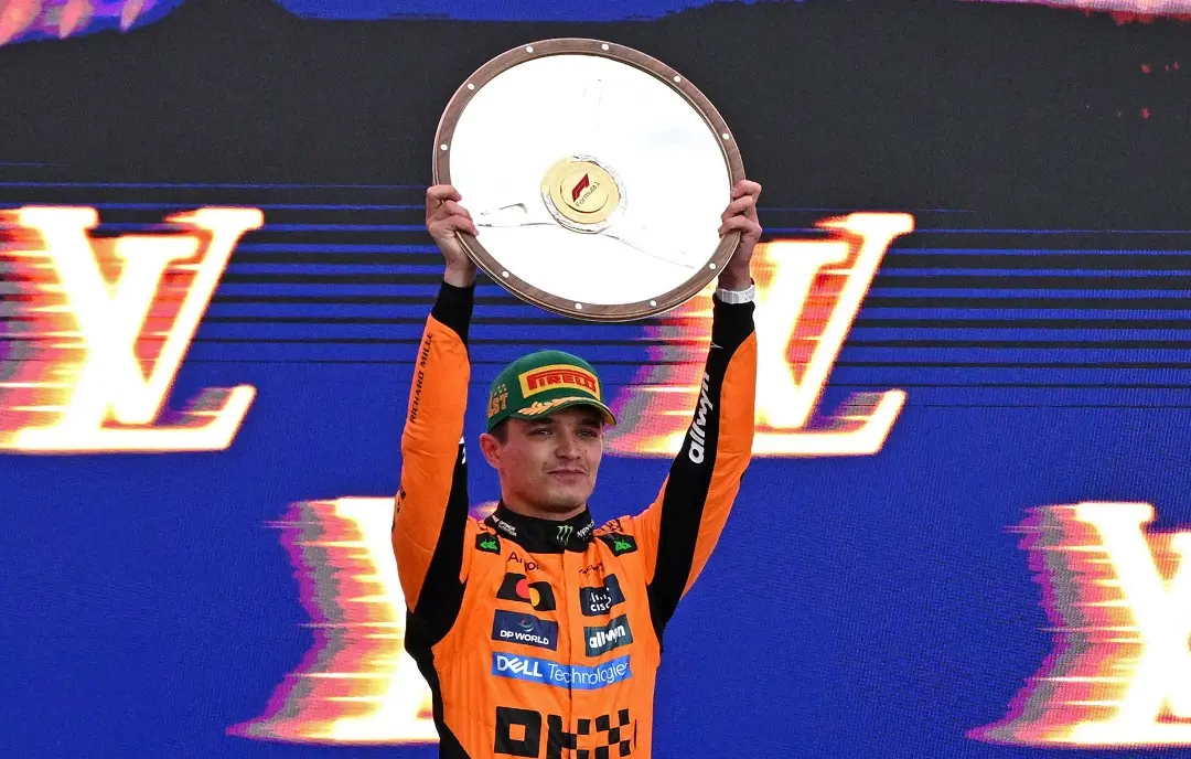First-placed McLaren's British driver Lando Norris celebrates on the podium with his trophy after winning the Australian Formula One Grand Prix at Albert Park Circuit in Melbourne | Photo: AFP