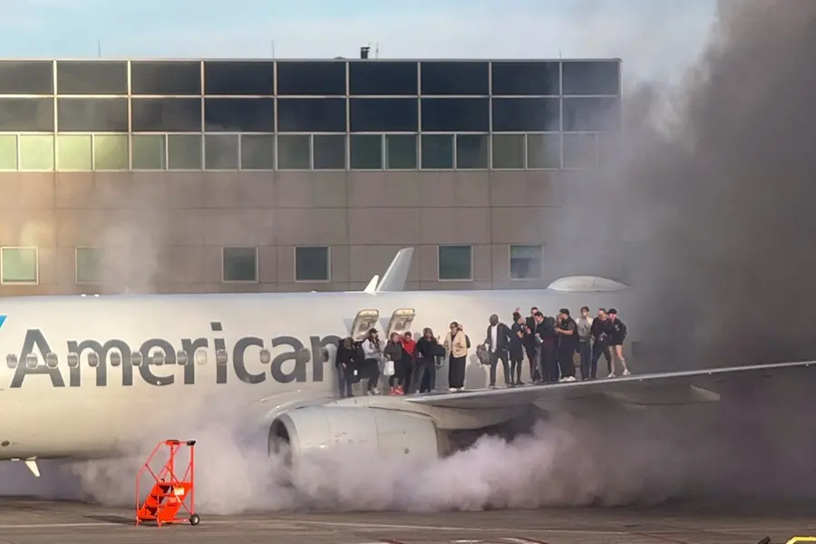American Airlines flight catches fire at Denver airport; Passengers evacuated | WATCH