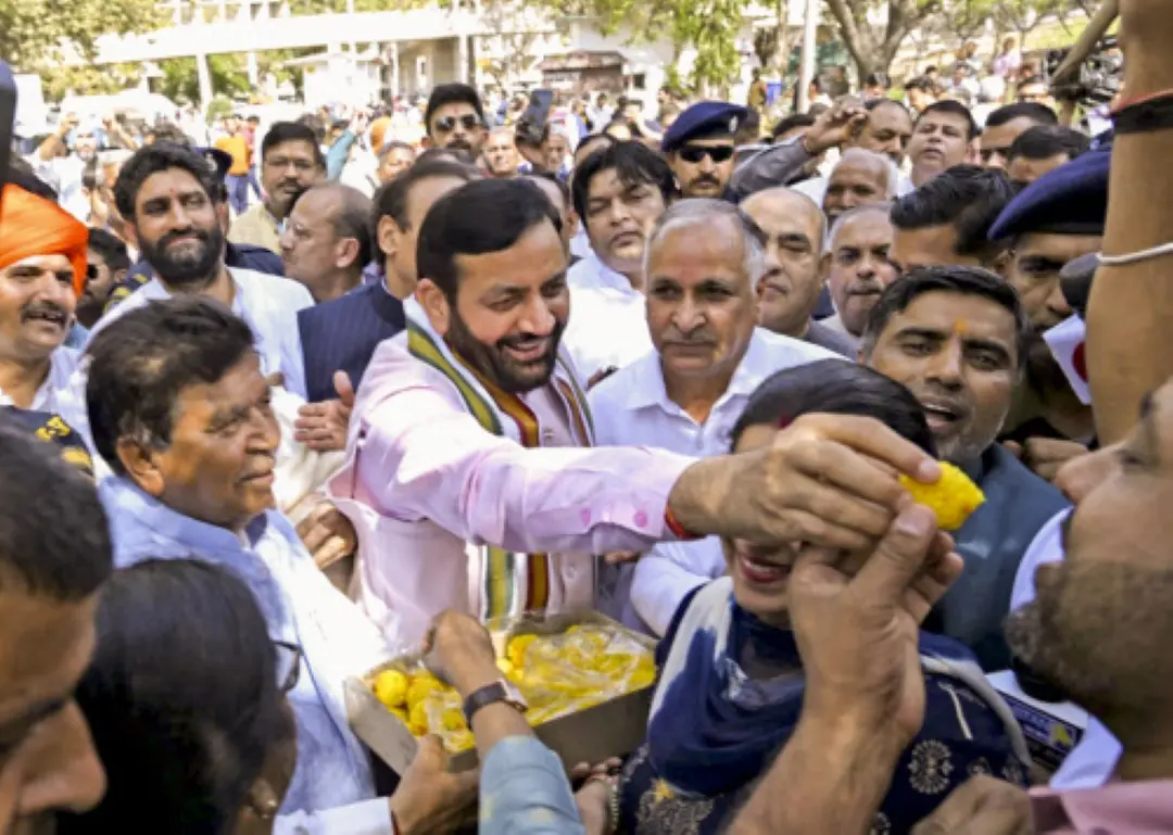 Haryana Chief Minister Nayab Singh Saini distributes sweets after BJP's mayoral candidates registered victories in civic polls | Photo: PTI