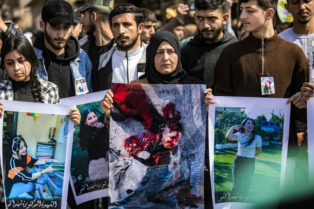 People gather for a mass demonstration in Syria's northeastern city of Qamishli, protesting against a recent wave of sectarian violence targeting Syria's Alawite minority in the west of the country along the Mediterranean sea coast | Photo: AFP