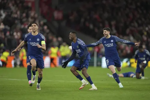 PSG players celebrate after the Champions League round of 16 second leg soccer match between Liverpool and Paris Saint-Germain at Anfield in Liverpool, England, Tuesday, March 11, 2025. | Photo: AP