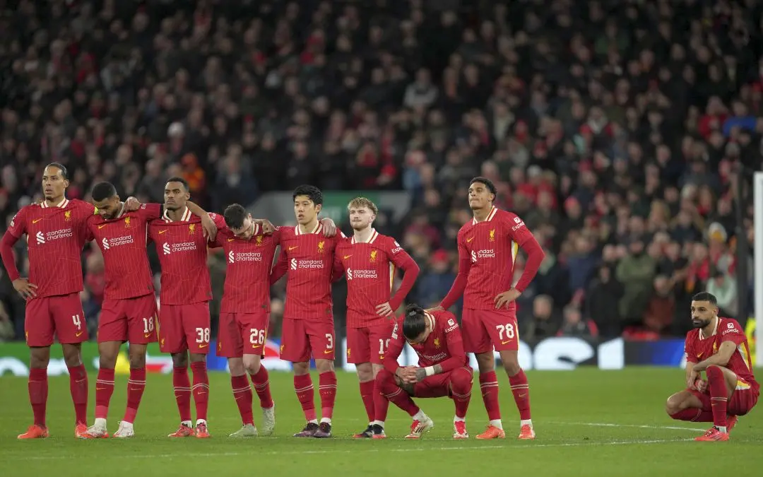 Liverpool players stand dejected during penalty shootout during the Champions League round of 16 second leg soccer match between Liverpool and Paris Saint-Germain at Anfield in Liverpool, England