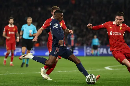 Paris Saint-Germain's French forward Ousmane Dembele (C) shoots towards goal during the UEFA Champions League Round of 16 first leg football match between Paris Saint-Germain (FRA) and Liverpool (ENG) at the Parc des Princes stadium in Paris on March 5, 2025. | Photo: AFP