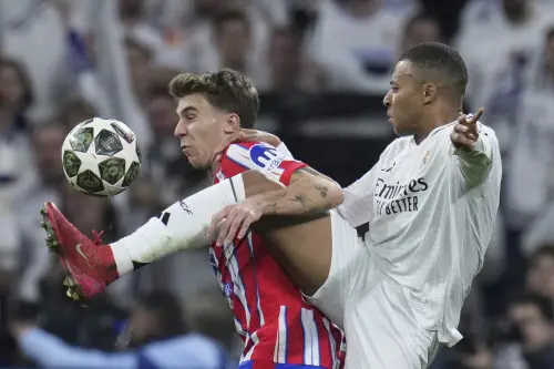 Atletico Madrid's Pablo Barrios, left, fights for the ball with Real Madrid's Kylian Mbappe during the Champions League round of 16 first leg soccer match between Real Madrid and Atletico Madrid at the Bernebeu stadium in Madrid, Spain, Tuesday, March 4, 2025. | Photo: AP
