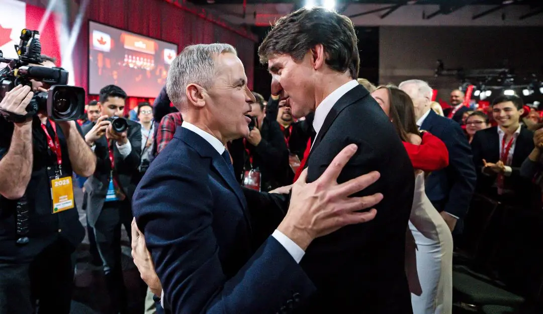 Mark Carney, Leader of the Liberal Party of Canada, embraces Prime Minister Justin Trudeau after being announced the winner at the Liberal leadership event in Ottawa, Ontario, on Sunday,