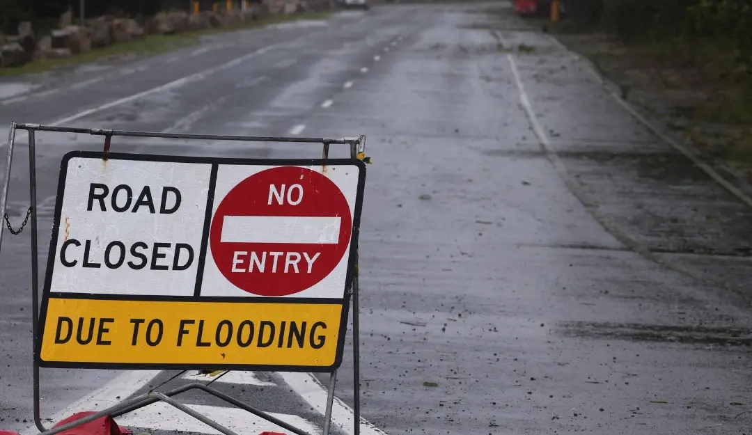 A sign warns of a road closure due to flooding from Cyclone Alfred in Labrador, Australia.