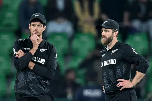 New Zealand's captain Mitchell Santner (L) and his teammate Kane Williamson gesture during the ICC Champions Trophy one-day international (ODI) semi-final cricket match between New Zealand and South Africa at the Gaddafi Stadium in Lahore on March 5, 2025. | Photo: AFP