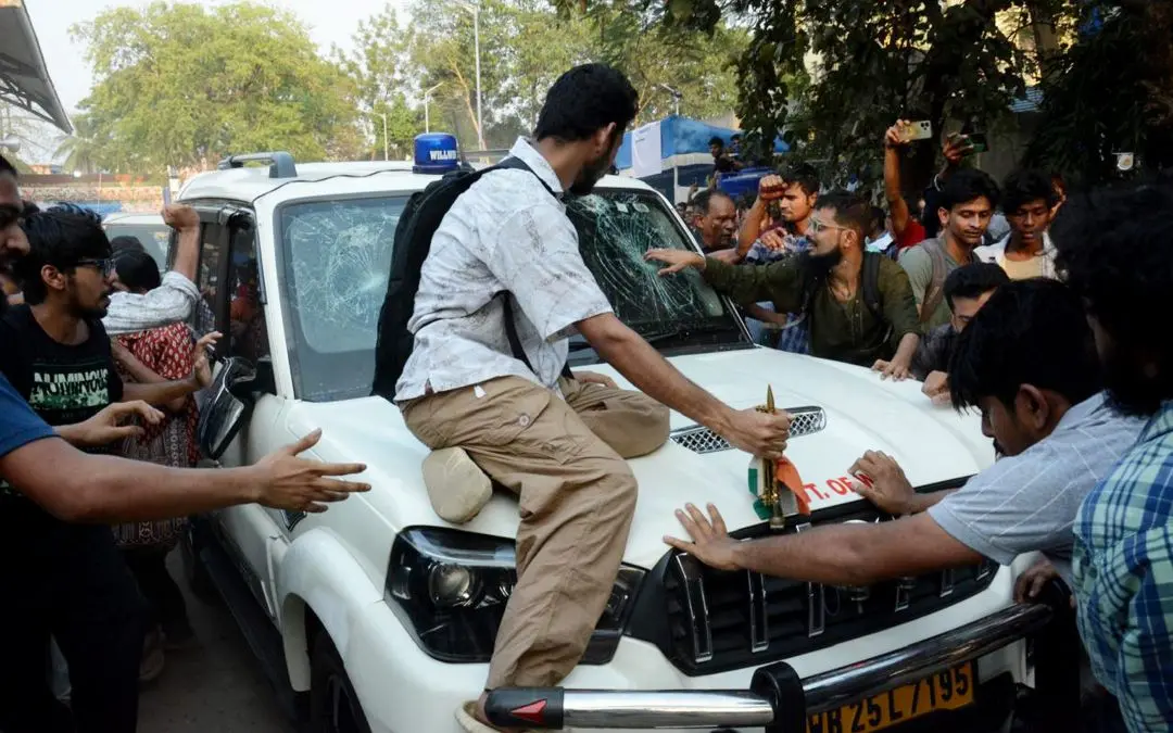 Students' Federation of India (SFI) members gather around West Bengal Education Minister Bratya Basu's car at Jadavpur University campus, in Kolkata, Saturday