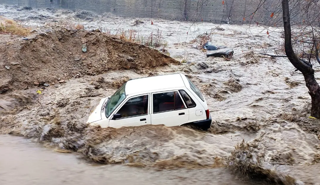 A vehicle is buried in sludge following flash floods, in Kullu (Photo: ANI)