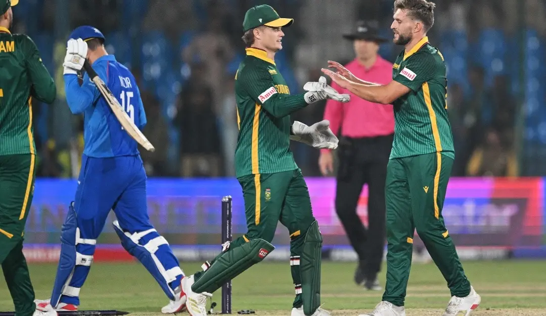South Africa's Wiaan Mulder (R) celebrates with teammate Ryan Rickelton after bowling out Afghanistan's Noor Ahmad (L) during the ICC Champions Trophy one-day international (ODI) cricket match between Afghanistan and South Africa at the National Stadium in Karachi.