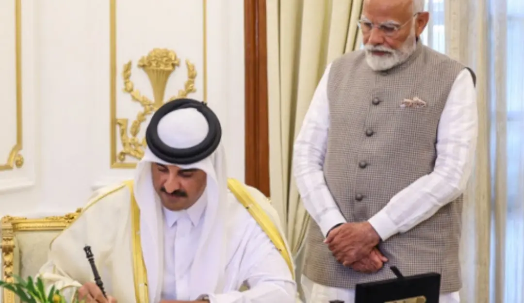 Sheikh Tamim Bin Hamad Al Thani, Amir of the State of Qatar signs the visitors book in the presence of PM Narendra Modi.