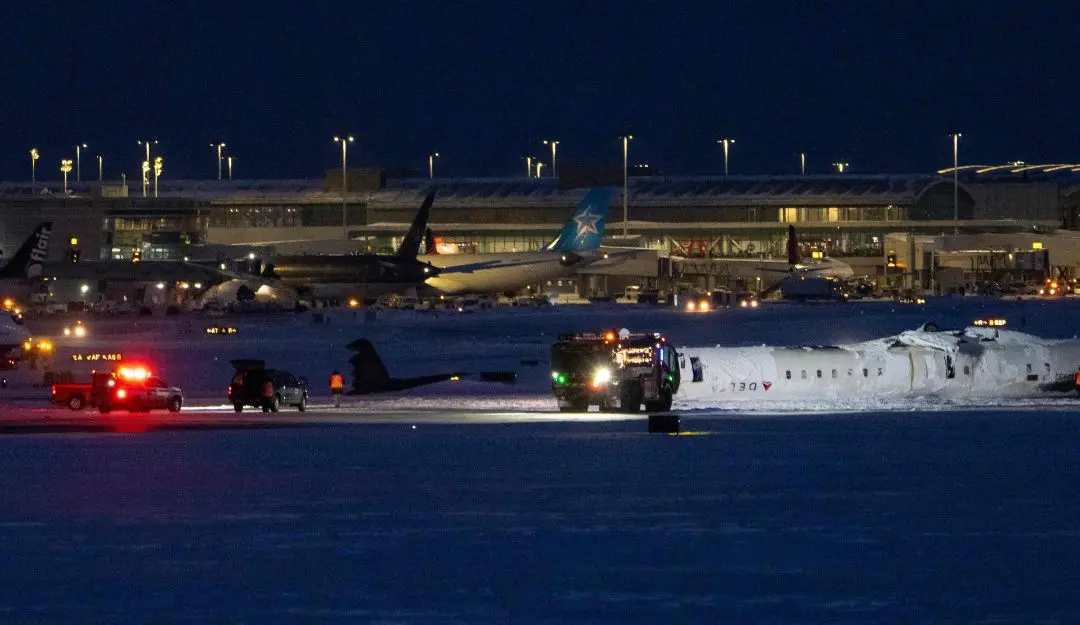 The Delta Airlines plane lies overturned after crashing earlier in the day at Toronto Pearson International Airport | Photo: AFP
