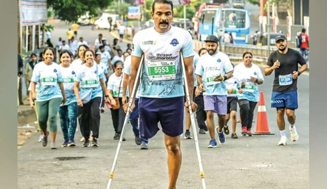 EC Vinod running on crutches in the Thrissur Cultural Capital Marathon on Sunday morning