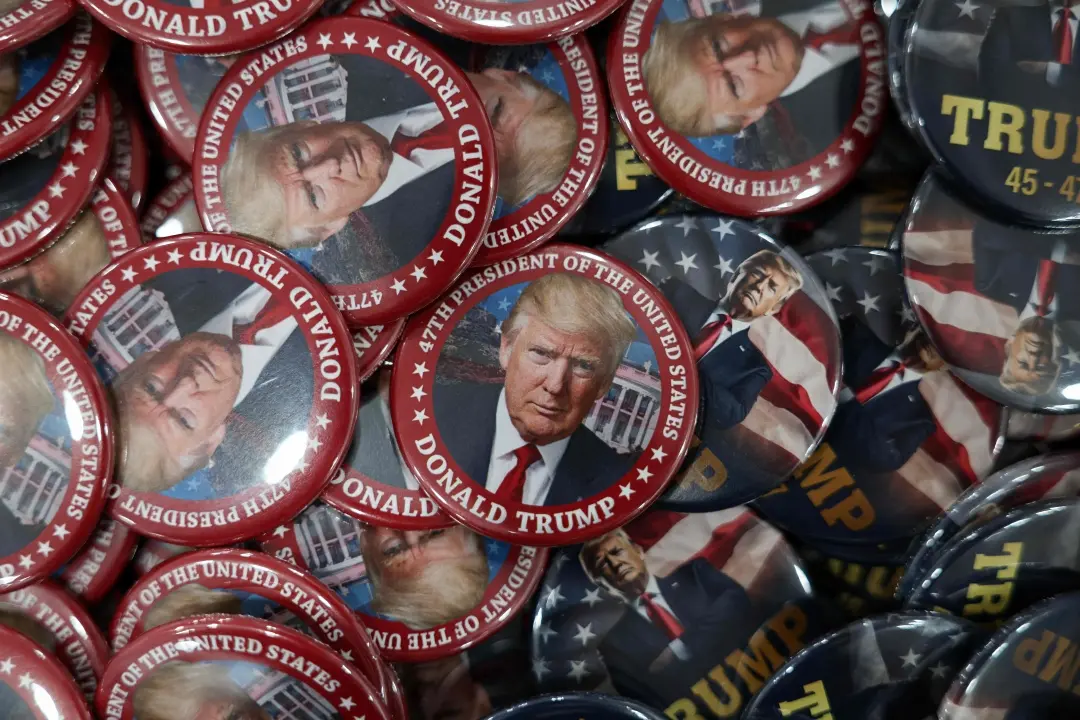 Donald Trump pins are displayed in a store ahead of the Inauguration | Photo: AFP