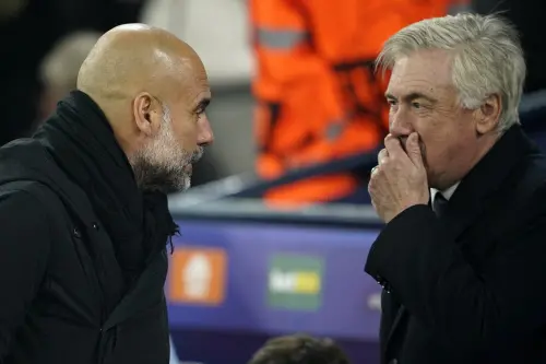 Real Madrid's head coach Carlo Ancelotti, right, talks to Manchester City's head coach Pep Guardiola before the start of the Champions League playoff first leg soccer match between Manchester City and Real Madrid at the Etihad Stadium in Manchester, England | Photo: AP