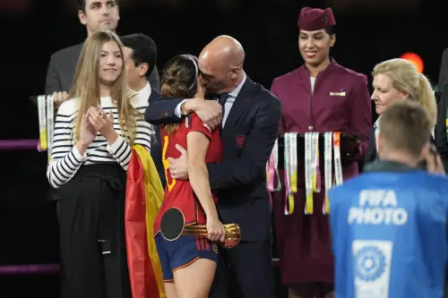 President of Spain's soccer federation, Luis Rubiales, right, hugs Spain's Aitana Bonmati on the podium following Spain's win in the final of Women's World Cup soccer against England at Stadium Australia in Sydney, Australia, Sunday, Aug. 20, 2023. At left is Spain's Princess Infanta Sofia | Photo: AP, file
