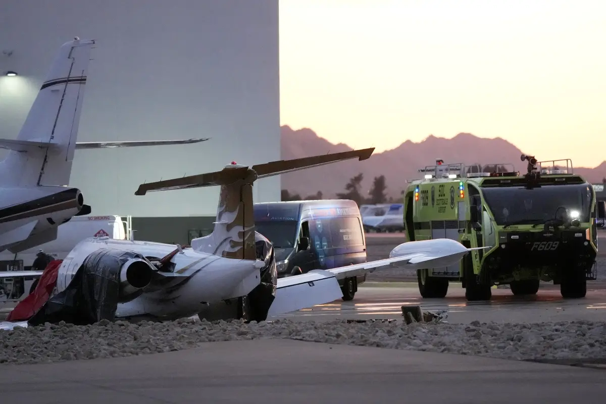 A crashed Learjet sits next to a plane it collided with as Scottsdale Airport Fire Department vehicle sits nearby at Scottsdale Airport | Photo: AP
