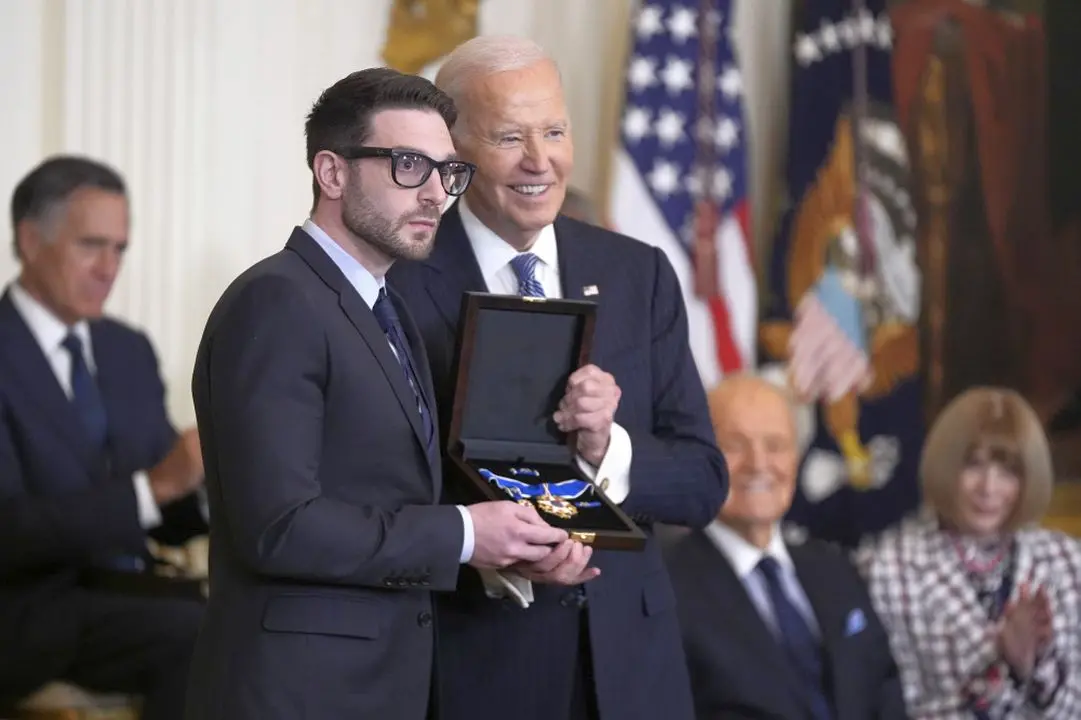 Alex Soros accepts the Medal of Freedom on behalf of his father George Soros from United States President Joe Biden during a ceremony at the White House in Washington, DC.