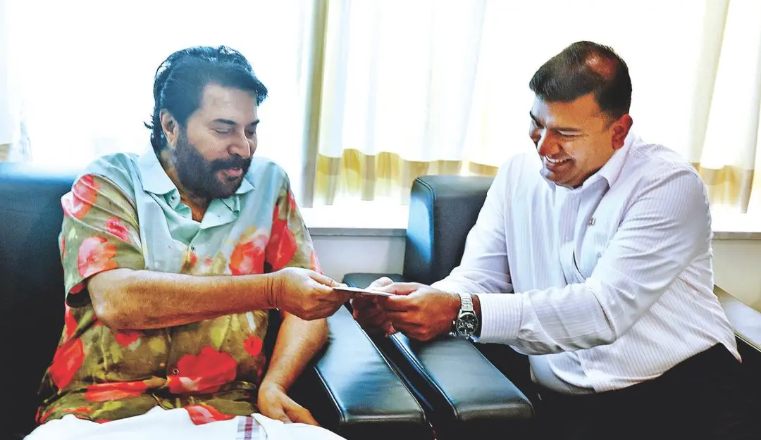 Jinson Anto Charles, Australia's first Indian-origin minister and also a Malayali, presents the official invitation letter from the Australian government to Mammootty. | Photo: MV Sinoj