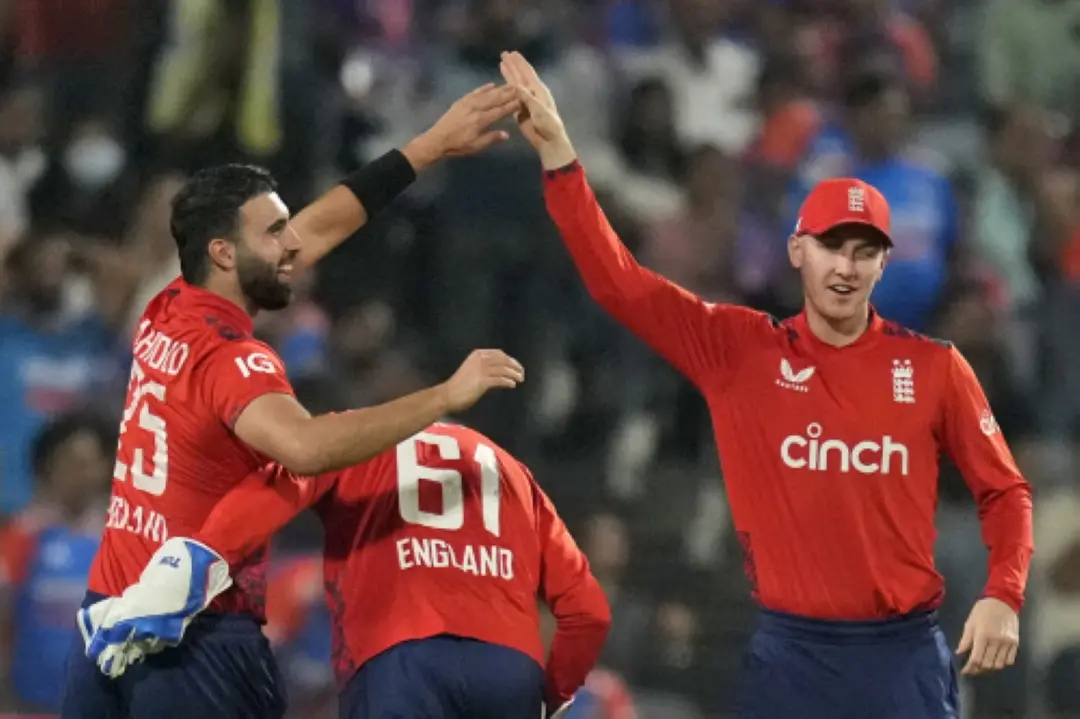 England's Saqib Mahmood, left, celebrates with teammates the wicket of India's Tilak Varma during the fourth T20 cricket match between England and India in Pune. | Photo: AP