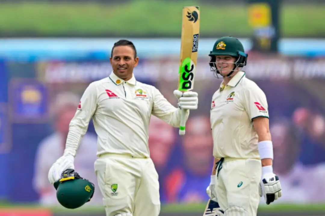 Australia's Usman Khawaja (L) celebrates with captain Steve Smith after scoring a century (100 runs) during the first day of the first Test cricket match between Sri Lanka and Australia at the Galle International Cricket Stadium in Galle. | Photo: AFP