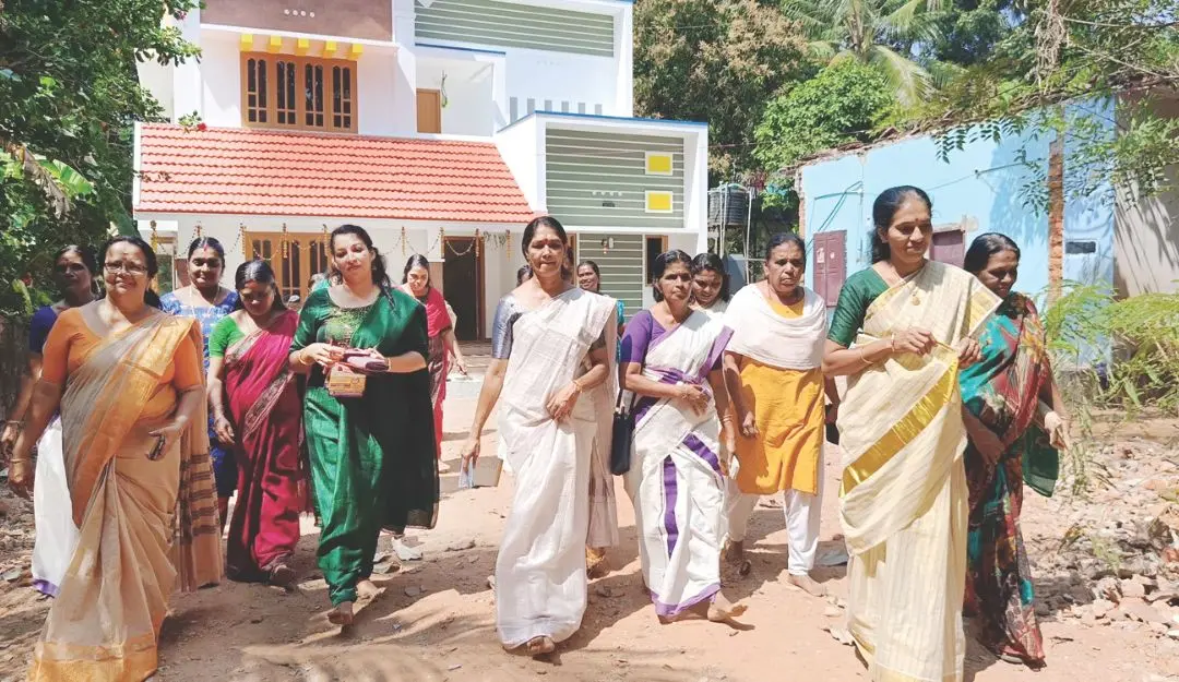 Women organisers of Porunnanarkkavu Devi Temple busy delivering festival announcements to homes