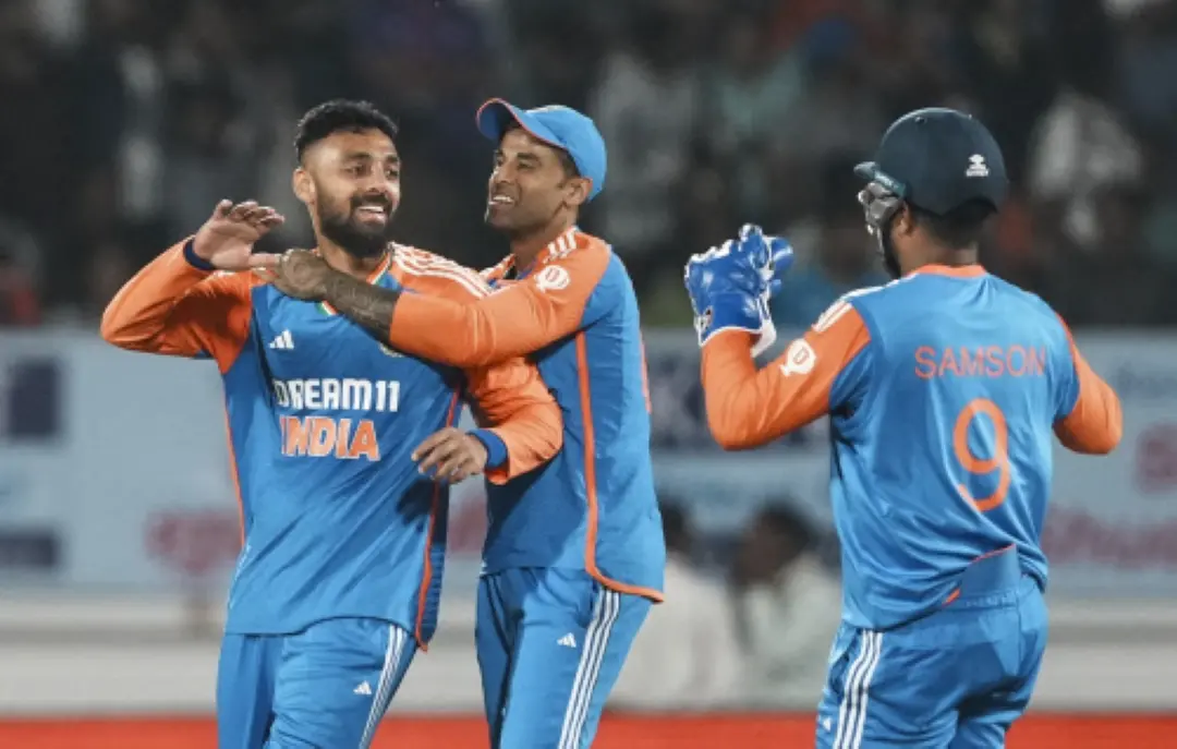 Varun Chakravarthy with teammates celebrates the wicket of England's Jofra Archer during the third T20 cricket match between India and England at the Niranjan Shah Stadium in Rajkot. | Photo: PTI