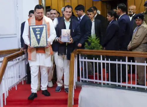 Uttarakhand Chief Minister Pushkar Singh Dhami with others holds a copy of the Constitution of India, at Vidhan Sabha Bhawan, in Dehradun on Tuesday. (Photo: PTI)