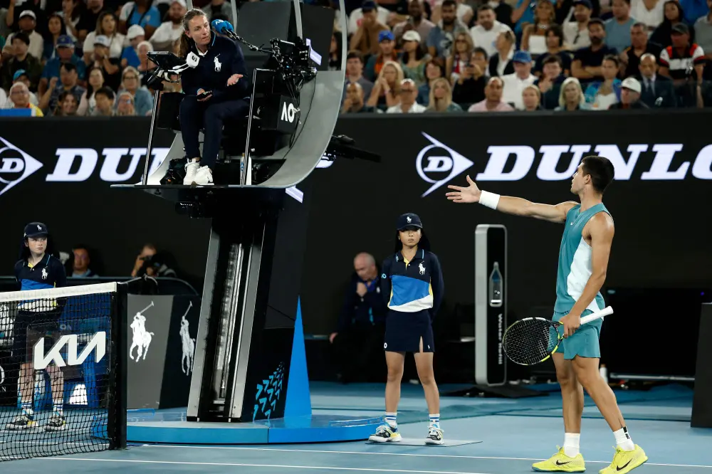 Carlos Alcaraz argues with the umpire over a point against Serbia's Novak Djokovic during their men's singles quarterfinal match | AFP