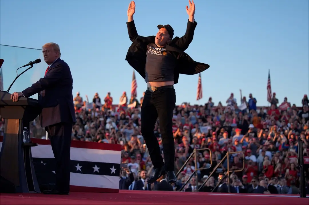 Elon Musk jumps on the stage as incoming US President Donald Trump speaks during a campaign rally | File Photo: AP
