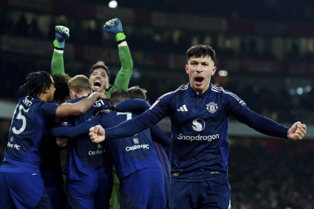 Manchester United's Lisandro Martinez, right, celebrates after winning the shoot-out during the English FA Cup soccer match between Arsenal and Manchester United | AP