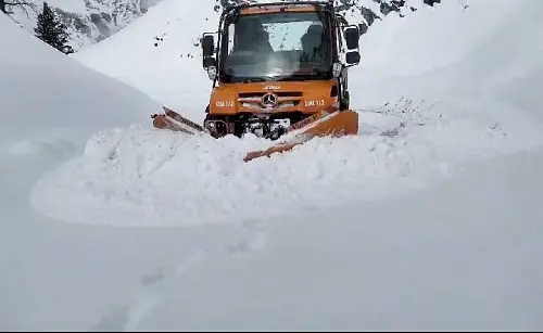 A snow-clearing machine removes snow to restore vehicular movement, at Mughal Road in Poonch. | ANI
