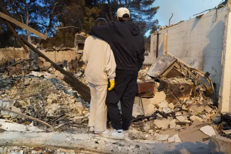 Families in shock begin to visit their charred homes in Los Angeles area