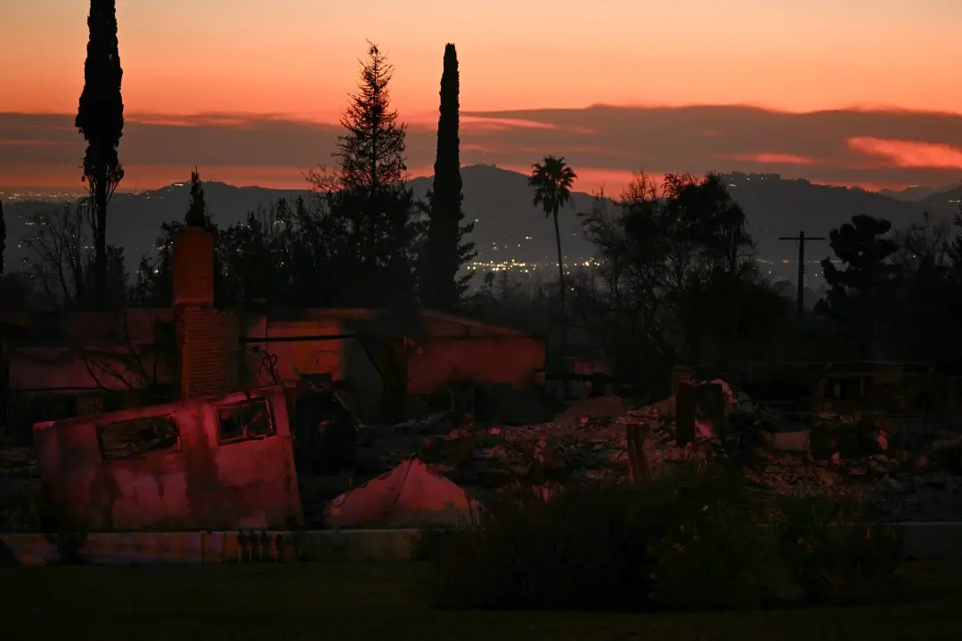 The Mt. Wilson Observatory (back, C) can be seen in the distance behind the remnants of a home destroyed during the Eaton Fire in Altadena, California | Photo: AFP