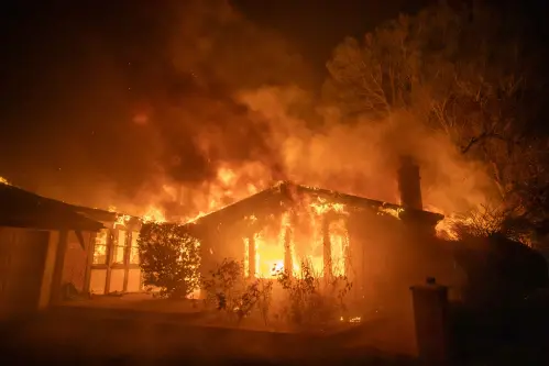 Thousands flee as wildfires burn out of control in Los Angeles