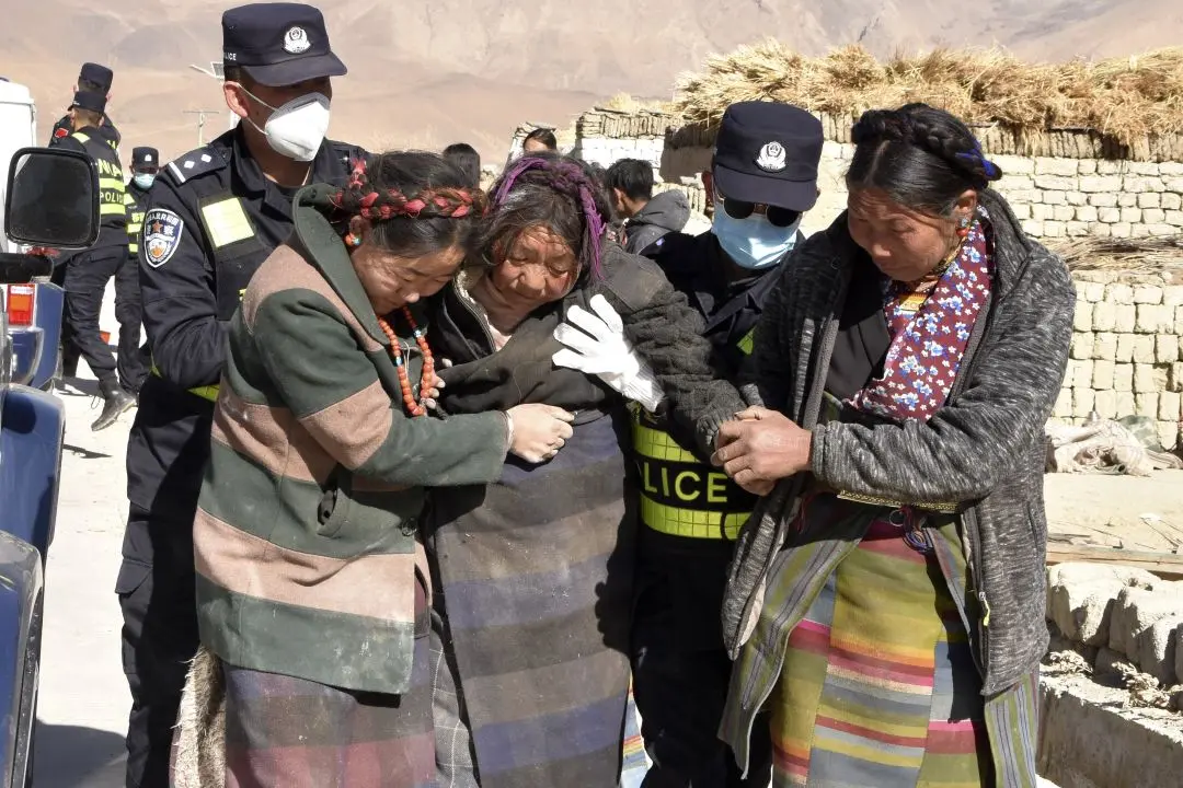 In this photo released by Xinhua News Agency, rescuers transfer the injured at Zhacun Village of Dingri County in Xigaze, southwest China's Tibet Autonomous Region, Tuesday Jan. 7, 2025.