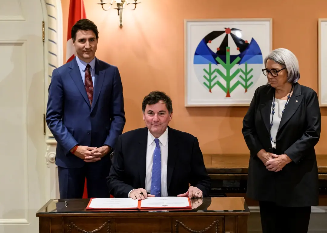 Prime Minister Justin Trudeau and Gov. Gen. Mary Simon look on as Dominic LeBlanc, Minister of Finance, Public Safety and Intergovernmental Affairs, participates in a signing during a swearing in ceremony at Rideau Hall in Ottawa