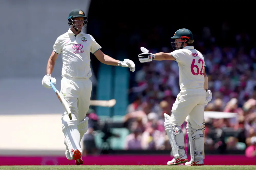 Travis Head (R) and team mate Beau Webster react during day three of the fifth cricket Test match | AFP