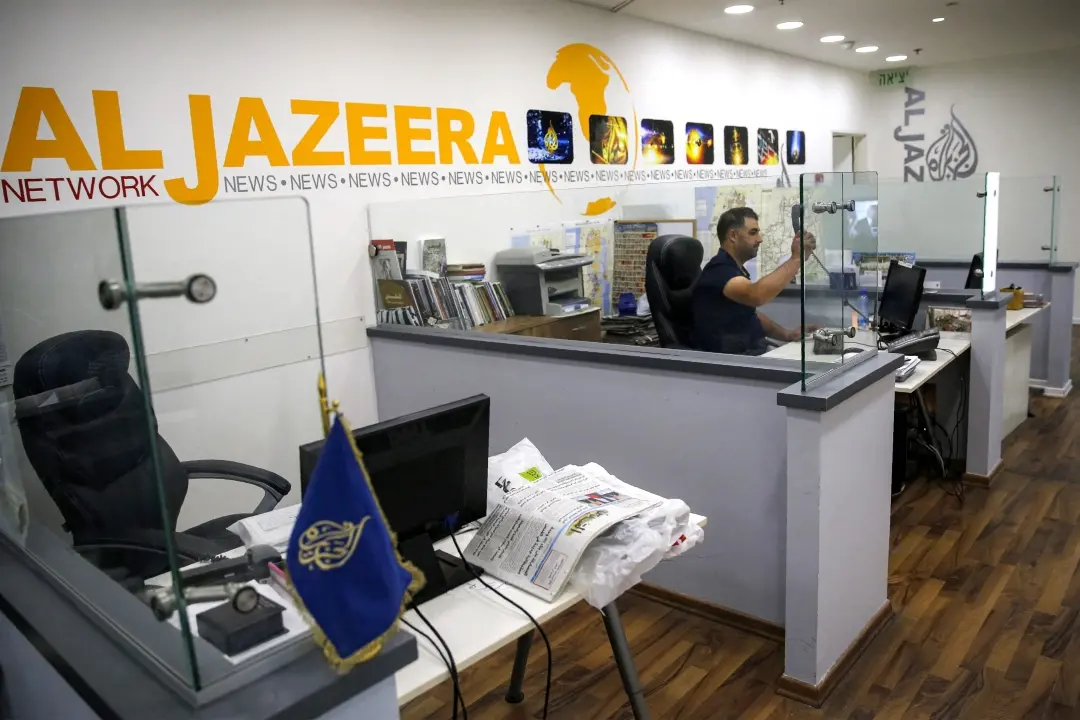 An employee of the Qatar based news network and TV channel Al-Jazeera is seen at the channel's Jerusalem office | File Photo: AFP
