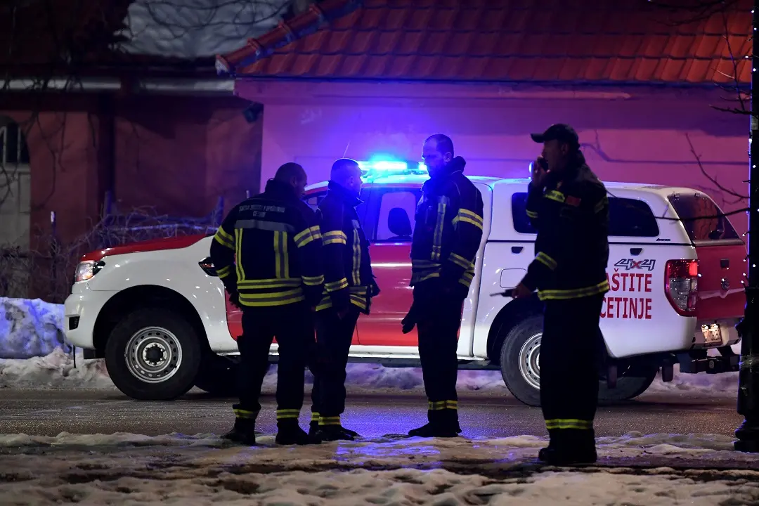 Police officers and civil protection units secure a crime scene after a gunman killed several people in the village of Bajice near Cetinje, on January 1 | Photo: AFP