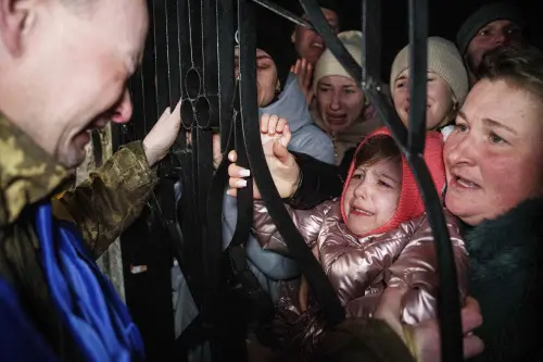 A Ukrainian serviceman cries upon seeing his daughter after returning from captivity