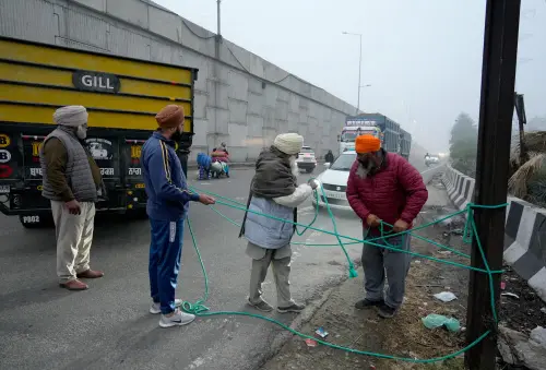 Farmers block a road during the statewide 'bandh' called as part their ongoing protest in Amritsar. | PTI