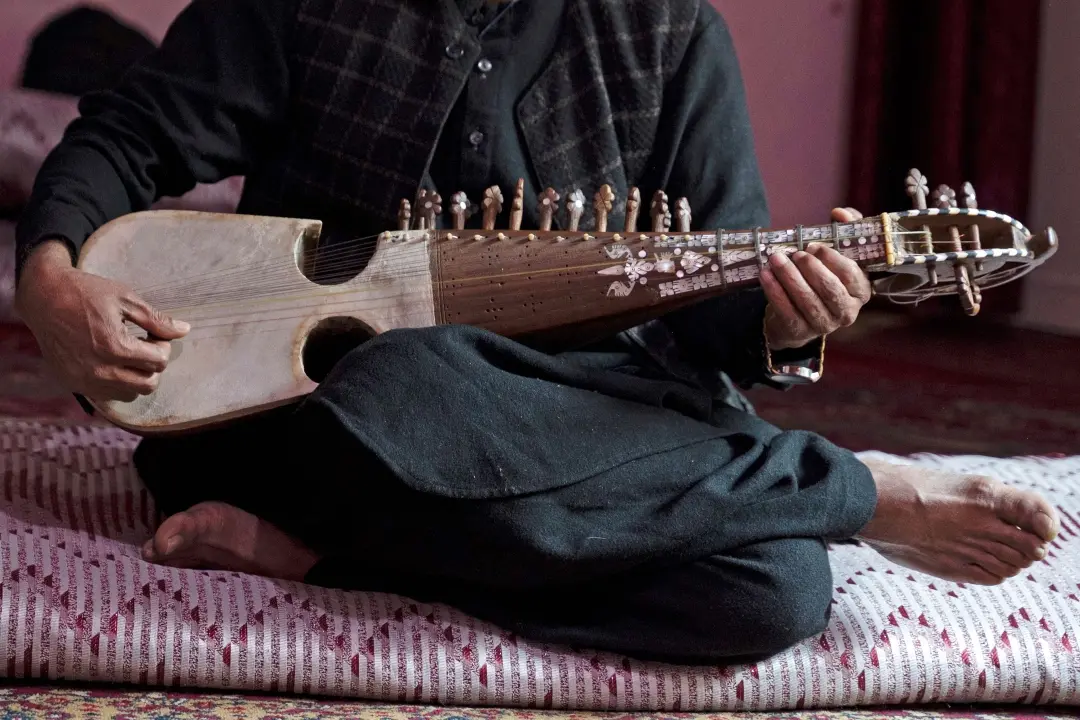 Afghan musician Majid plays the rubab instrument at a house in Kabul | Photo: AFP
