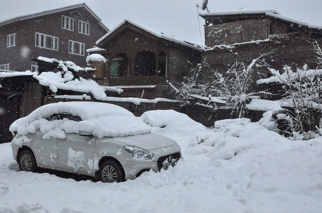 A car and its surroundings covered in a thick layer of snow after heavy snowfall in Kashmir Valley | Photo: ANI
