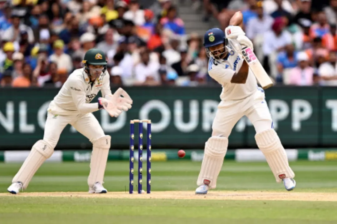 Nitish Kumar Reddy (R) plays a shot as Australia's Alex Carey (L) watches on the third day of the fourth cricket Test match between Australia and India at the Melbourne Cricket Ground (MCG) in Melbourne. | Photo:AFP