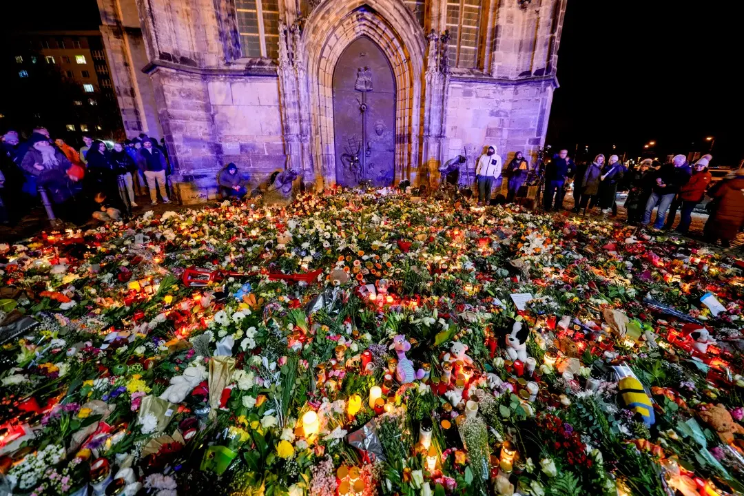 People have laid flowers and candles in front of the Johannis church close to the Christmas market, where a car drove into a crowd on Friday evening, in Magdeburg, Germany | Photo: AP